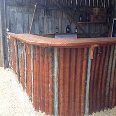 an outdoor bar made out of metal and wood