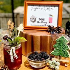 a table topped with jars filled with different types of drinks and decorations on top of it