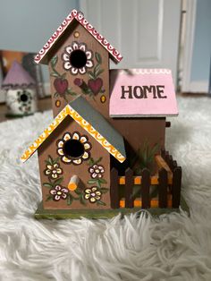 a bird house with flowers painted on it