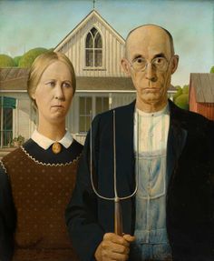 two men standing next to each other in front of a house with a large pitchfork