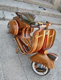 a wooden scooter is parked on the side of the street in front of some steps