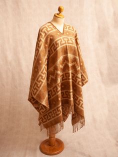 WE SHIP VIA DHL EXPRESS, ESTIMATED DELIVERY TIME IS APPROXIMATELY 5 TO 7 DAYS. PLEASE SEND US BY ETSY MESSAGE YOUR CELL PHONE NUMBER AND YOUR UPDATED EMAIL ADDRESS. This unique and beautiful poncho is made by Peruvian artisans with alpaca wool, a very fine and soft wool, one of the most sought after for its incredible qualities such as elasticity and resistance. This poncho is perfect for the winter and autumn seasons because its fiber is highly warm. It has an Andean tribal design, and its colo Traditional Brown Cape For Fall, Traditional One-size Cape For Fall, Traditional One Size Cape For Fall, Traditional Beige Poncho For Winter, Traditional One-size Fall Cape, Traditional Shawl Poncho For Fall, Traditional One Size Poncho For Fall, Traditional Handwoven Poncho For Fall, Traditional Fall Cape Shawl