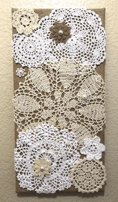 crocheted doily is hanging on the wall