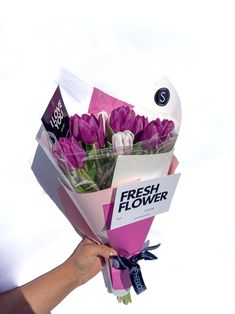 a person holding a bouquet of flowers in their hand with the words fresh flower on it