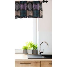 a kitchen with a sink, window and potted plants