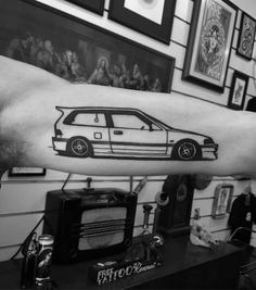 a person with a car tattoo on their arm