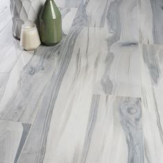 a white and grey marble floor with vases on the side