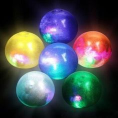 four different colored balls in the dark