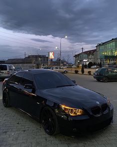 a black car parked on the side of a road