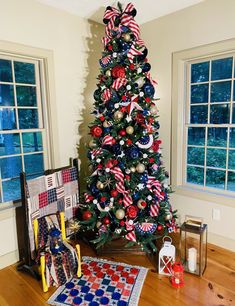 a christmas tree decorated with red, white and blue ribbons