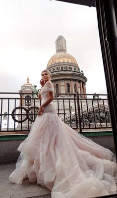 a woman in a wedding dress is posing for a photo