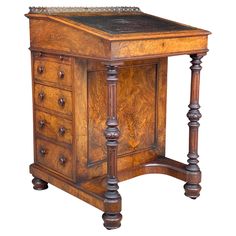 an old wooden desk with drawers on one side and a marble top on the other