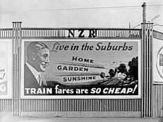 an old black and white photo of a train advertisement on the side of a building