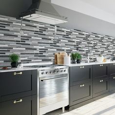 a kitchen with stainless steel appliances and gray cabinets