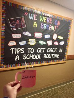 a person holding up a sign that says tips to get back in a school routine