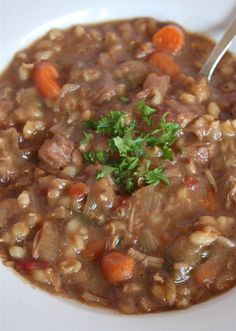 a white bowl filled with beans and carrots