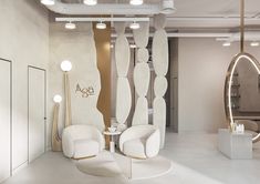 the interior of a salon with white furniture and mirrors on the wall, along with two chairs