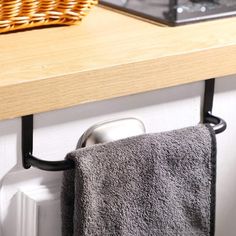 a towel hanging on a rack next to a stove