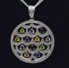 Gorgeous vintage sterling silver circular chandelier pendant, with a hinged bail (for easy removal), set with round cut diamonds, and dangling round cut gems of peridot, aquamarine, garnet, citrine, and amethyst. Amazingly beautiful piece, especially for someone who loves gemstones. The round cut dangles are about 4mm diameter, diamonds are about 1mm diameter. The pendant is on an Italian multi-strand sterling silver chain necklace, with an extension chain. 15 diamonds, 2 peridot, 3 aquamarine, Silver Multi-stone Diamond Gemstones, Multi-stone Diamond Jewelry With Round Stones, Multi-stone Diamond Pendant Gemstones, Multi-stone Diamond Round Pendant, Multi-stone Diamond Round Pendant Jewelry, Silver Multi-stone Dangle Gemstones, Fine Jewelry Multi-stone Round Pendant, Silver Multi-stone Round Cut Gemstones, Multi-stone Diamond Dangle Jewelry