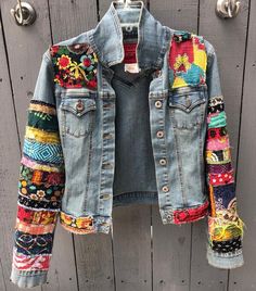 a jean jacket with colorful patches on it