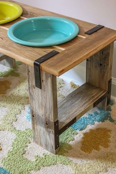 a wooden table with two plates on it and a rug in front of the table