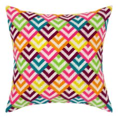 the multicolored pillow is shown on a white background and has a diamond pattern