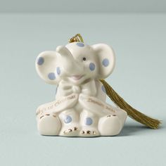 an elephant ornament with a tassel hanging from it's back