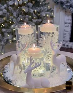 three lit candles sitting on top of a tray