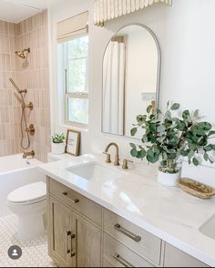 a bathroom with a sink, toilet and bathtub next to a window in it