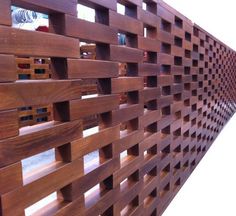 a close up of a wooden fence with holes in the middle and wood slats on each side