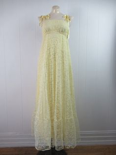 "Vintage 1960s or 70s summer prairie dress. Made of yellow acrylic lace with matching lace jacket. Dress has a yellow Rayon inner shell, empire waist, bow ties shoulder straps, elastic band above and below the bust. No designer label. Size small/medium. Dress measures: 35\" around the bust 21\"(stretches to 28\") at the elastic under the bust 42\" around the hips 48\" overall length Top measures: 37\" around the bust 37\" around the waist 13.5\" shoulder seam to shoulder seam 25\" shoulder seam Vintage Lace Dress For Summer, Summer Empire Waist Lace Maxi Dress, Summer Lace Vintage Dress, Summer Lace Maxi Dress With Empire Waist, Yellow Lace Maxi Dress For Summer, Vintage Lace Patchwork Dress For Summer, Vintage Lace Dress With Patchwork For Summer, Vintage Summer Lace Dress With Patchwork, Retro Lace Dresses For Spring