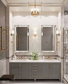 a bathroom with two sinks, mirrors and lights on the wall next to each other