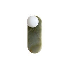 an egg is sitting on top of a green and white marbled object that looks like it's floating in the air