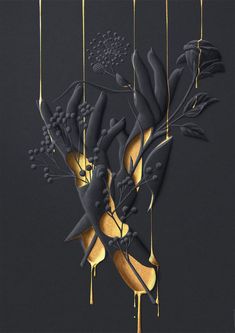 some gold and black flowers are hanging from the ceiling in front of a dark background