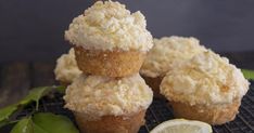 three lemon muffins stacked on top of each other next to a slice of lime