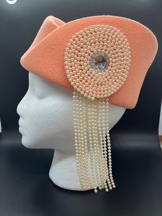 "This is a striking vintage hat in a pretty peach color.  This is a formed, rigid hat with art-deco style, done in 100% wool.  It measures 22.5\" around the inside rim of the hat.  The name of the company, style, and origin are all printed inside the hat, but I cannot make out any of the words except 100% Wool.  The large ornament on the side is a clear glass rhinestone surrounded by a circle of faux pearls and hanging pearl strands.  The pearls are plastic and lightweight, but with a nice drape Jewelry Christmas Tree, Pale Peach, Unique Hats, Vintage Handkerchiefs, Vintage Hat, Pearl Strands, Red Rhinestone, Peach Color, Vintage Costume Jewelry