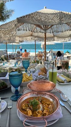 an outdoor dining area with plates of food on the table