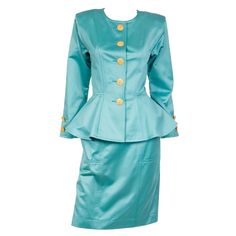 We love vintage Yves Saint Laurent and find that his pieces truly stand the test of time! This is a 1991 Deadstock YSL two piece green polished cotton suit with a collarless peplum jacket and straight skirt. The pretty peplum jacket has princess seams and gold engraved buttons that look like mandalas. These buttons go down center front and are found on the sleeve cuffs. There are built in shoulder pads for structure and the jacket is unlined. The slim skirt has a fixed waistband and front pocket Saint Laurent Vintage, Vintage Yves Saint Laurent, Slim Skirt, Peplum Jacket, Rive Gauche, Princess Seams, Love Vintage, Straight Skirt, Princess Seam