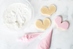 some cookies and marshmallows are on a table with other items to make them