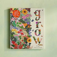 a book with flowers and letters on it