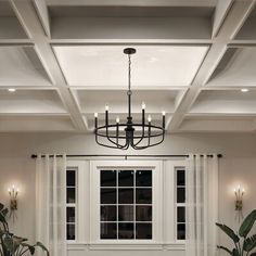 a living room filled with furniture and a chandelier