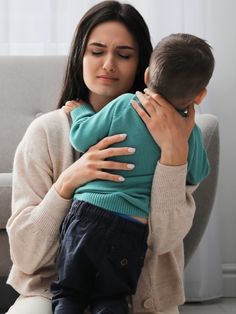 a woman holding a small child in her arms