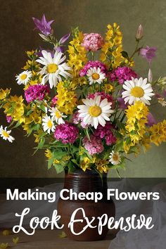 a vase filled with lots of flowers sitting on top of a table