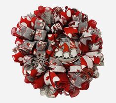 a red and white christmas wreath with santa hats on it