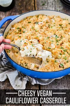 a blue casserole dish filled with cheesy vegan cauliflower casserole