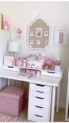 a white desk topped with drawers and a pink ottoman next to a wall mounted mirror