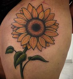 a sunflower tattoo on the back of a woman's thigh