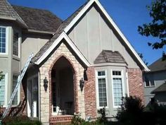 a brick house with white trim and windows