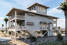 a two story house on the beach with palm trees