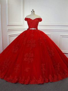 a red ball gown on display in front of a mirror